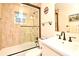 Bathroom featuring a shower with glass door and tiled walls, sink, toilet and vanity at 507 N Peninsula Ave, New Smyrna Beach, FL 32169