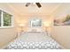 Bright bedroom featuring wood floors, ceiling fan, neutral walls, and windows with lush greenery at 507 N Peninsula Ave, New Smyrna Beach, FL 32169