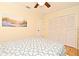 Bright bedroom featuring light walls, closet, ceiling fan, and beach artwork for a relaxing atmosphere at 507 N Peninsula Ave, New Smyrna Beach, FL 32169