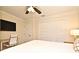 Comfortable bedroom with ceiling fan, art, television, closet, and a convenient desk area at 507 N Peninsula Ave, New Smyrna Beach, FL 32169