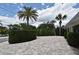 Paver driveway surrounded by lush landscaping, offering ample parking and curb appeal at 507 N Peninsula Ave, New Smyrna Beach, FL 32169