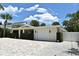 Exterior front view of the home featuring a paver driveway and trimmed hedges at 507 N Peninsula Ave, New Smyrna Beach, FL 32169