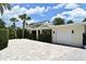 Inviting one-story home with a brick driveway, lush landscaping, and a convenient garage at 507 N Peninsula Ave, New Smyrna Beach, FL 32169