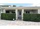Inviting home entrance with trimmed hedges and a charming, covered front porch at 507 N Peninsula Ave, New Smyrna Beach, FL 32169