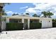 Charming single-story home featuring a manicured lawn, brick driveway, and an attached one car garage at 507 N Peninsula Ave, New Smyrna Beach, FL 32169