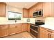 This beautifully updated kitchen features wood cabinets, granite counters, stainless appliances, and an eat-in breakfast bar at 507 N Peninsula Ave, New Smyrna Beach, FL 32169