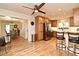 Eat-in kitchen featuring custom cabinets, stainless steel appliances, hardwood floors and a view into the dining area at 507 N Peninsula Ave, New Smyrna Beach, FL 32169