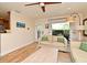 Inviting living room featuring hardwood floors, a neutral sofa and a large window overlooking the patio at 507 N Peninsula Ave, New Smyrna Beach, FL 32169