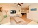 Open-concept living room with hardwood floors, neutral sofas and a view into the dining area at 507 N Peninsula Ave, New Smyrna Beach, FL 32169