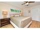 Spacious main bedroom featuring wood floors, ceiling fan, neutral walls, and and closets at 507 N Peninsula Ave, New Smyrna Beach, FL 32169