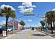 Street view on Flagler Avenue with shops and palm trees, leading towards the beach at 507 N Peninsula Ave, New Smyrna Beach, FL 32169