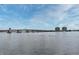 Scenic view of the bridge and waterfront with high-rise buildings against a cloudy blue sky at 507 N Peninsula Ave, New Smyrna Beach, FL 32169