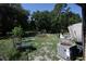 Overgrown backyard with discarded items and an air conditioning unit at 5262 Lescot Ln, Orlando, FL 32811