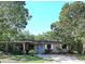 Charming single-story home with a front porch and mature shade trees at 5262 Lescot Ln, Orlando, FL 32811