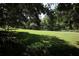 Lush green space features mature trees, offering a serene and picturesque outdoor area at 5262 Lescot Ln, Orlando, FL 32811