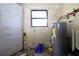 Utility room with outdated hot water heater and concrete block walls at 5262 Lescot Ln, Orlando, FL 32811