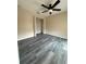 Bedroom showcasing closet, ceiling fan and dark-stained hardwood flooring at 626 Old Pine Ct, Sanford, FL 32773