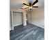 Bedroom featuring closet, ceiling fan, and dark-stained hardwood floors at 626 Old Pine Ct, Sanford, FL 32773
