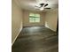 A simple bedroom with a ceiling fan, a window with blinds, and hard wood floors at 626 Old Pine Ct, Sanford, FL 32773