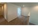 Upstairs bedroom features carpeted floors and interior door to hallway at 710 Junonia Blvd, New Smyrna Beach, FL 32168