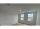Upstairs bedroom with carpeted floors and two windows with views outside at 710 Junonia Blvd, New Smyrna Beach, FL 32168