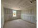 A bedroom under construction showcases natural light from a window, plus smooth drywall installation at 710 Junonia Blvd, New Smyrna Beach, FL 32168