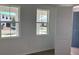 Bright bedroom features two large windows offering neighborhood views and a convenient door at 710 Junonia Blvd, New Smyrna Beach, FL 32168