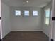 Well-lit room with modern flooring, multiple windows, and fresh, neutral paint at 710 Junonia Blvd, New Smyrna Beach, FL 32168