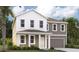 Charming two-story home with a covered front porch, complemented by lush landscaping and a two-car garage at 710 Junonia Blvd, New Smyrna Beach, FL 32168