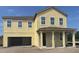 Newly constructed home featuring an inviting front porch and an attached two-car garage in a developing neighborhood at 710 Junonia Blvd, New Smyrna Beach, FL 32168