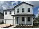 Charming two-story home with light gray and white siding, well-manicured landscaping, and covered front porch at 710 Junonia Blvd, New Smyrna Beach, FL 32168