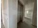 Open doorway into a raw room with unfinished drywall and concrete floors at 710 Junonia Blvd, New Smyrna Beach, FL 32168