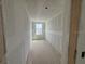 Hallway under construction with natural light from the window at 710 Junonia Blvd, New Smyrna Beach, FL 32168