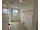 Clean laundry room with a bright window at 710 Junonia Blvd, New Smyrna Beach, FL 32168
