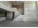 Large living room under construction, featuring a staircase and high ceilings for a bright, open design at 710 Junonia Blvd, New Smyrna Beach, FL 32168