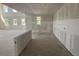 Open living room space in progress, awaiting your custom finishes, with views to the outside and kitchen at 710 Junonia Blvd, New Smyrna Beach, FL 32168