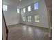 Spacious living room with tall windows, modern flooring, and plenty of natural light at 710 Junonia Blvd, New Smyrna Beach, FL 32168