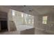 Spacious, unfinished living room with a staircase and high ceilings, creating an airy and modern feel at 710 Junonia Blvd, New Smyrna Beach, FL 32168