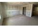 An unfinished room under construction with smooth drywall installation and a passageway into another part of the home at 710 Junonia Blvd, New Smyrna Beach, FL 32168