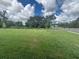 Large grassy lot showcasing a well-maintained lawn with mature trees, offering ample outdoor space at 710 Junonia Blvd, New Smyrna Beach, FL 32168