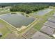 Aerial view of homes and community ponds with trees at 715 Auburn Grove Ct, Auburndale, FL 33823