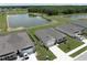 Aerial view of homes and community pond with trees at 715 Auburn Grove Ct, Auburndale, FL 33823