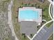 Aerial shot featuring a well-maintained community pool with a spacious lounge area and clubhouse at 715 Auburn Grove Ct, Auburndale, FL 33823