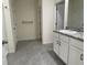 Bathroom featuring grey tile flooring, granite counters, single sink and white cabinetry at 715 Auburn Grove Ct, Auburndale, FL 33823