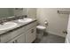 Bathroom features a double sink vanity with granite countertop and neutral tile floors at 715 Auburn Grove Ct, Auburndale, FL 33823