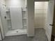 Bathroom features a stand-up shower, tile floors, and a closet with metal shelving units at 715 Auburn Grove Ct, Auburndale, FL 33823