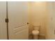 Bathroom featuring a standard toilet and door with brushed bronze hardware at 715 Auburn Grove Ct, Auburndale, FL 33823