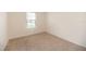 Bedroom with neutral carpet, window with blinds, and base trim at 715 Auburn Grove Ct, Auburndale, FL 33823