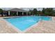 Stunning community pool featuring refreshing clear blue water and convenient access with stainless steel handrails at 715 Auburn Grove Ct, Auburndale, FL 33823