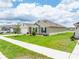 Charming single Gathering home with a manicured lawn, landscaping, and a two car garage at 715 Auburn Grove Ct, Auburndale, FL 33823